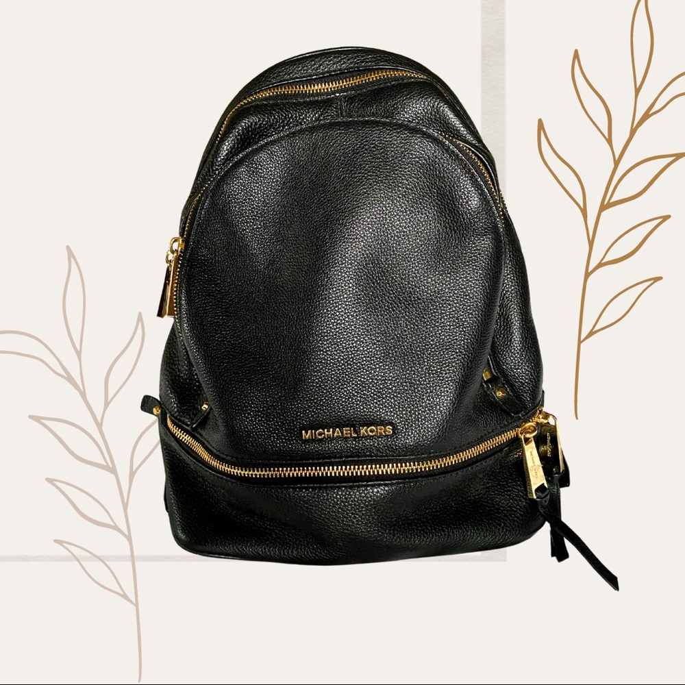 Michael Kors Backpack in Black with gold zippers.